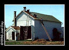 Amishmen fixing roof on barn near Lititz, Pennsylvania.