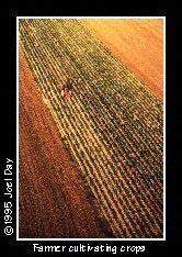 Aerial view of farmer cultivating crops with tractor near Rheems, Pennsylvania.